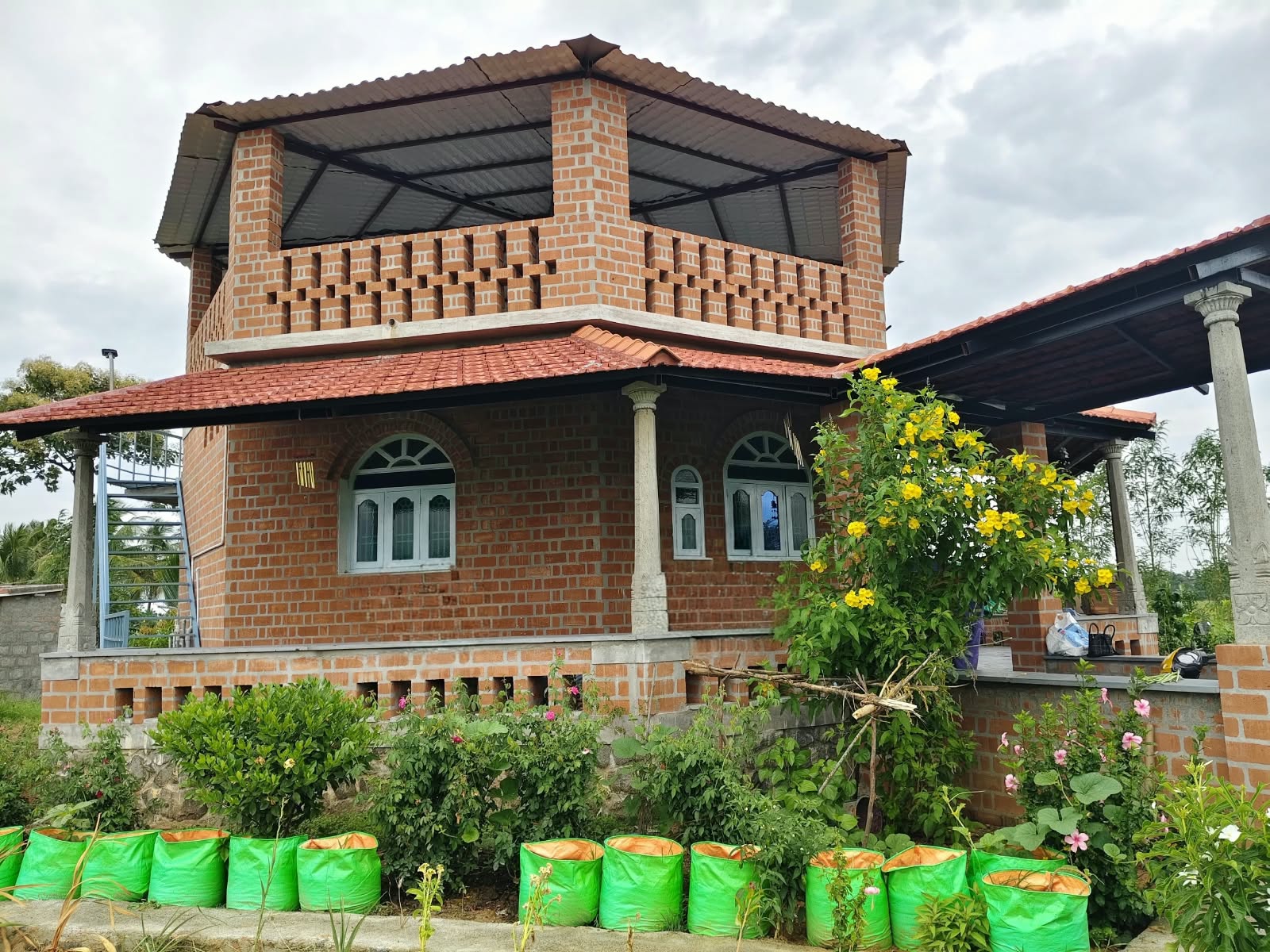 Joe's Nithilam brick farmhouse with terrace, veranda and flowering garden